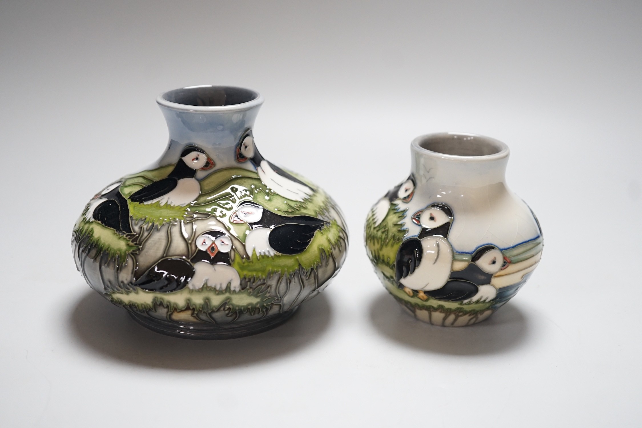 Three boxed Moorcroft ‘Puffin’ ceramics: a squat vase, a smaller vase and a dish, squat vase 11cms high